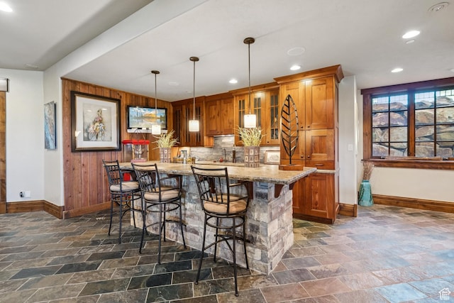 7881 N W Hills Trl, Park City, UT 84098 - bar area featuring stone tile flooring, recessed lighting, hanging light fixtures, wood walls, and decorative backsplash