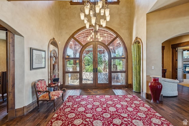 7881 N W Hills Trl, Park City, UT 84098 - entryway featuring french doors, a chandelier, hardwood / wood-style flooring, arched walkways, and healthy amount of natural light