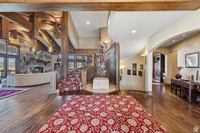 7881 N W Hills Trl, Park City, UT 84098 - living room featuring hardwood / wood-style flooring, arched walkways, a stone fireplace, stairway, and recessed lighting