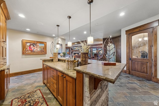 7881 N W Hills Trl, Park City, UT 84098 - kitchen featuring stone tile flooring, a large island, decorative light fixtures, recessed lighting, and light stone countertops