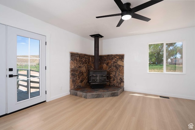 3189 S 4000 W, Roosevelt, UT 84066 - unfurnished living room with a wood stove, wood finished floors, and ceiling fan