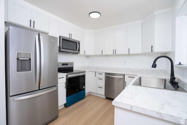 3189 S 4000 W, Roosevelt, UT 84066 - kitchen featuring stainless steel appliances, light wood-style flooring, white cabinets, and light stone countertops