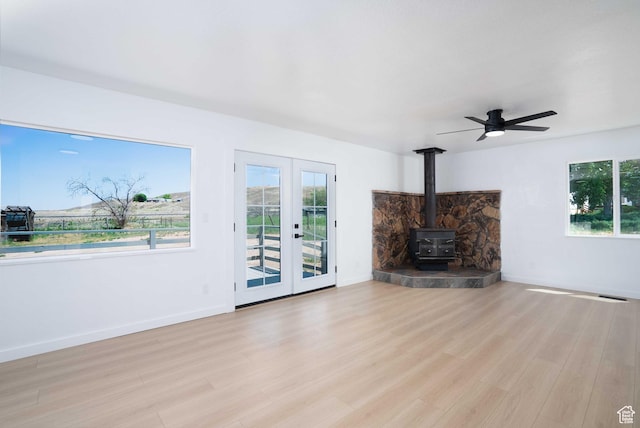 3189 S 4000 W, Roosevelt, UT 84066 - unfurnished living room with plenty of natural light, a wood stove, and wood finished floors