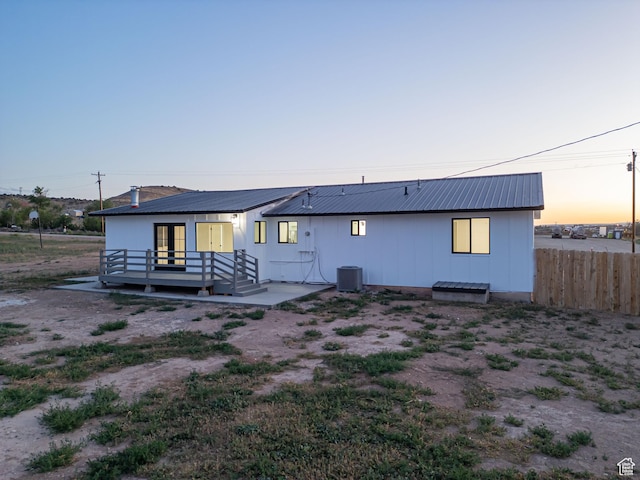 3189 S 4000 W, Roosevelt, UT 84066 - back of house at dusk featuring a metal roof, a deck, french doors, and board and batten siding