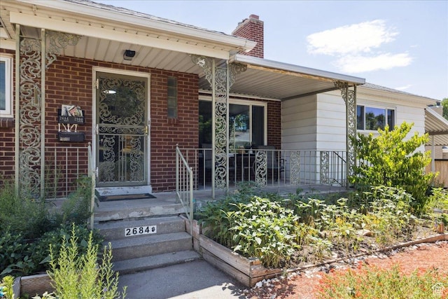 2684 E 2900 S, Millcreek, UT 84109 - property entrance featuring a porch, a chimney, and brick siding