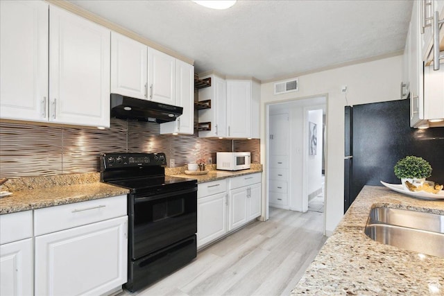2684 E 2900 S, Millcreek, UT 84109 - kitchen with black electric range, under cabinet range hood, white microwave, and white cabinetry