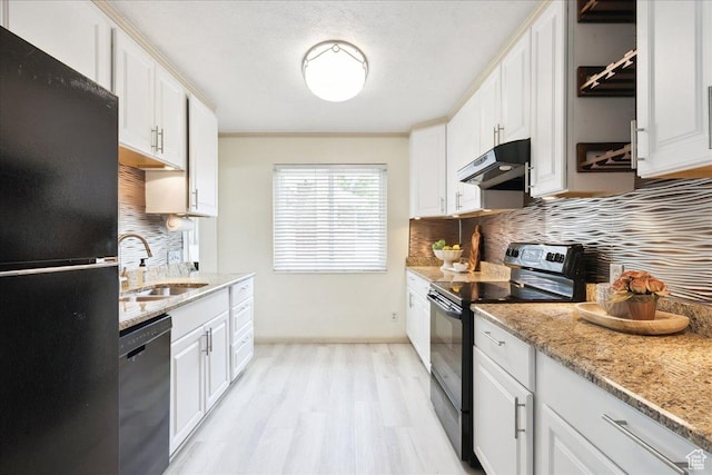 2684 E 2900 S, Millcreek, UT 84109 - kitchen with black appliances, under cabinet range hood, backsplash, light wood-type flooring, and white cabinetry