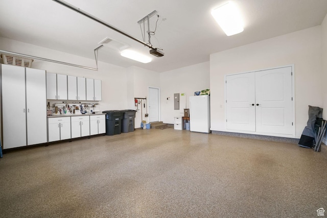 10693 S Vermillion Dr, South Jordan, UT 84009 - garage with freestanding refrigerator, electric panel, and a garage door opener