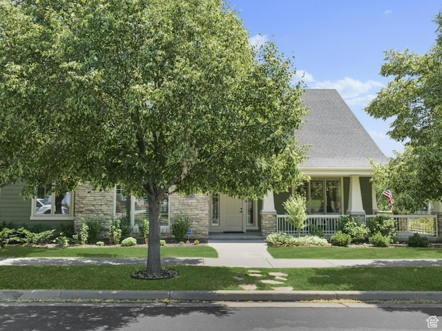 10693 S Vermillion Dr, South Jordan, UT 84009 - view of front of property with stone siding, a porch, and a front lawn