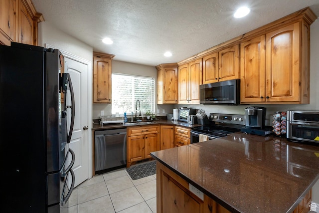 4018 W Cypress, Cedar Hills, UT 84062 - kitchen with appliances with stainless steel finishes, a peninsula, recessed lighting, brown cabinetry, and dark stone counters