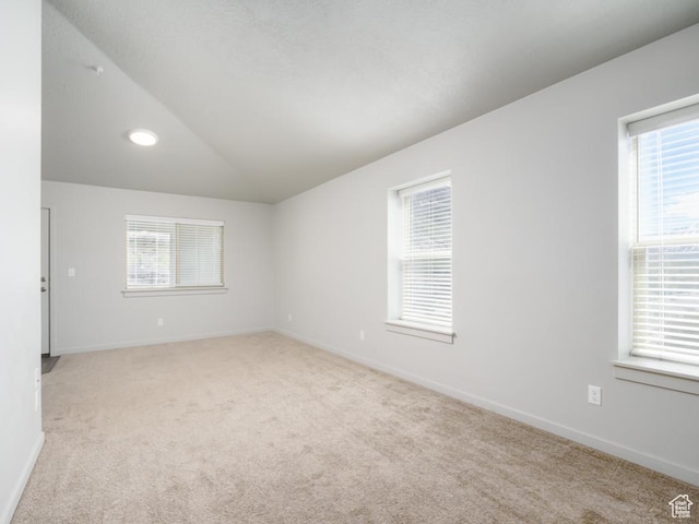 1141 E 1320 S Unit A401, Provo, UT 84606 - unfurnished room featuring light carpet, healthy amount of natural light, and lofted ceiling