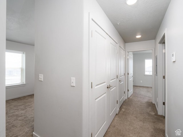 1141 E 1320 S Unit A401, Provo, UT 84606 - hall with carpet flooring, a textured ceiling, and healthy amount of natural light