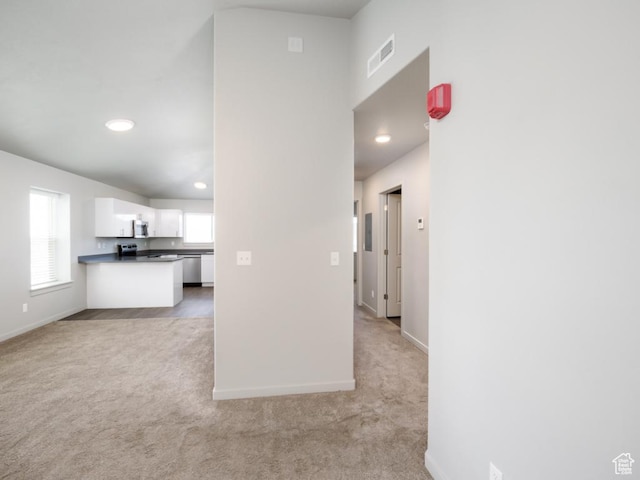 1141 E 1320 S Unit A401, Provo, UT 84606 - kitchen featuring light colored carpet, dark countertops, white cabinetry, appliances with stainless steel finishes, and recessed lighting
