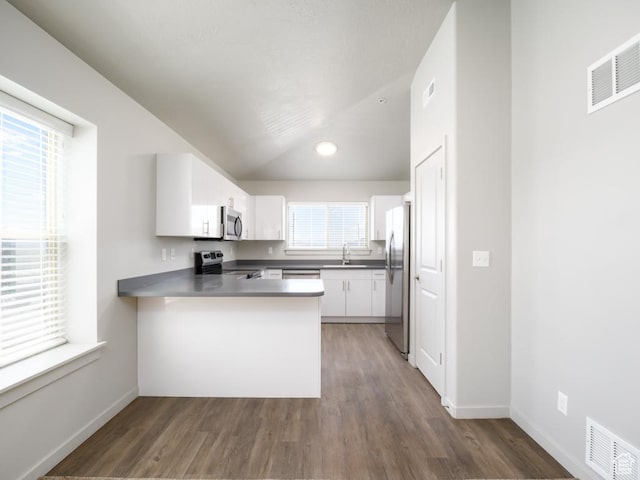 1141 E 1320 S Unit A401, Provo, UT 84606 - kitchen featuring appliances with stainless steel finishes, a peninsula, wood finished floors, white cabinetry, and recessed lighting