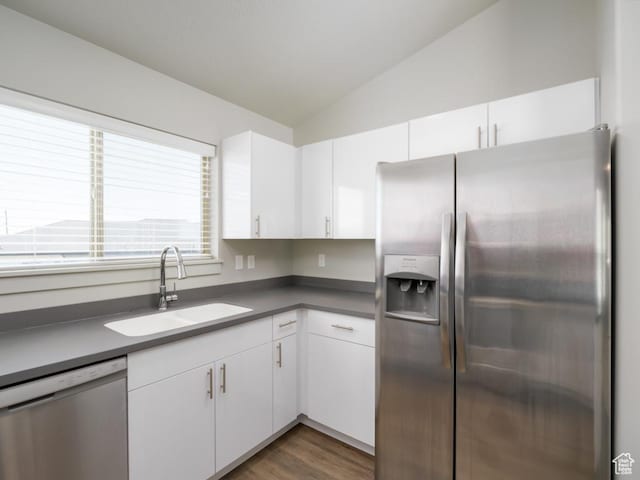 1141 E 1320 S Unit A401, Provo, UT 84606 - kitchen featuring appliances with stainless steel finishes, lofted ceiling, white cabinetry, wood finished floors, and dark countertops