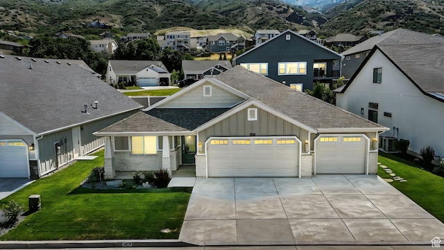 1470 N Cobblewood Ct, Kaysville, UT 84037 - view of front facade with board and batten siding, an attached garage, concrete driveway, brick siding, and a residential view