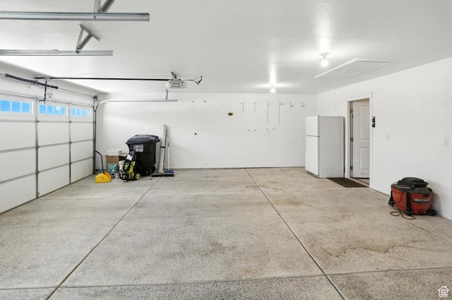 1470 N Cobblewood Ct, Kaysville, UT 84037 - garage featuring freestanding refrigerator and a garage door opener