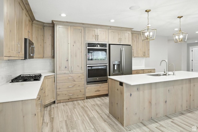 1470 N Cobblewood Ct, Kaysville, UT 84037 - kitchen featuring appliances with stainless steel finishes, light brown cabinets, recessed lighting, light wood-style flooring, and a chandelier