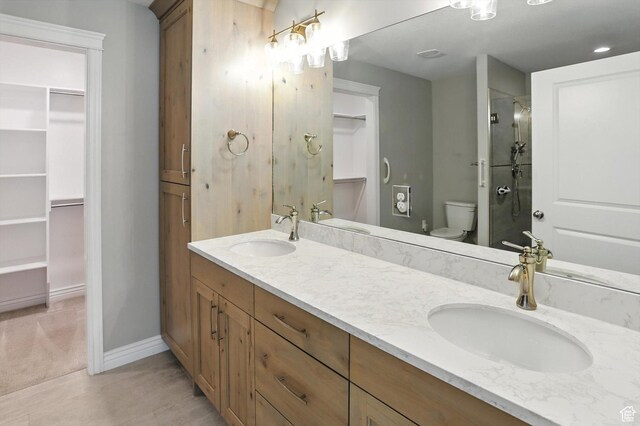 1470 N Cobblewood Ct, Kaysville, UT 84037 - bathroom featuring a walk in closet, double vanity, a shower with shower door, and tile patterned floors
