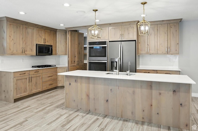 1470 N Cobblewood Ct, Kaysville, UT 84037 - kitchen with appliances with stainless steel finishes, light wood finished floors, decorative backsplash, a center island with sink, and light countertops