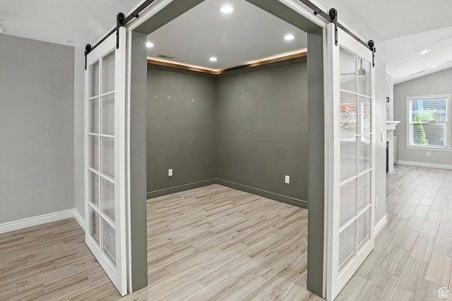 1470 N Cobblewood Ct, Kaysville, UT 84037 - unfurnished room featuring a barn door, wood finished floors, and recessed lighting