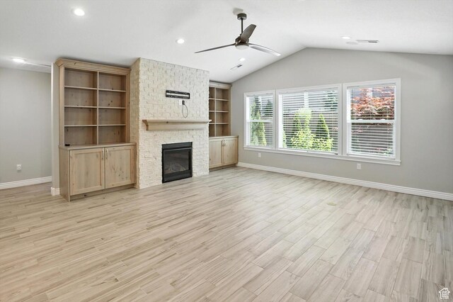1470 N Cobblewood Ct, Kaysville, UT 84037 - unfurnished living room with ceiling fan, light wood-style flooring, vaulted ceiling, a fireplace, and built in features