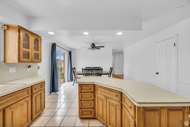 5350 S 3450 W, Roy, UT 84067 - kitchen featuring light countertops, brown cabinetry, a ceiling fan, glass insert cabinets, and recessed lighting
