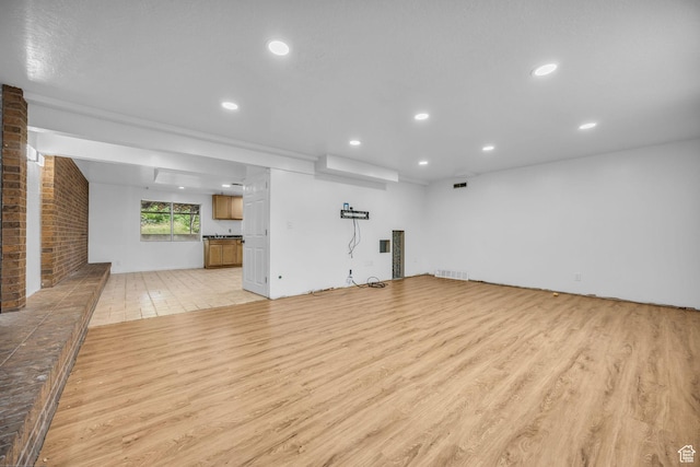 5350 S 3450 W, Roy, UT 84067 - unfurnished living room featuring light wood-style flooring and recessed lighting