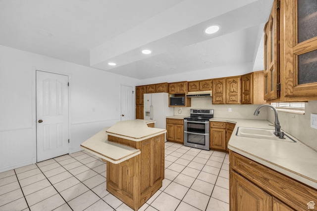 5350 S 3450 W, Roy, UT 84067 - kitchen featuring double oven range, white refrigerator with ice dispenser, under cabinet range hood, brown cabinetry, and light countertops