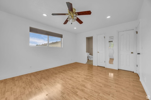 5350 S 3450 W, Roy, UT 84067 - unfurnished bedroom featuring multiple windows, light wood-style floors, recessed lighting, and connected bathroom
