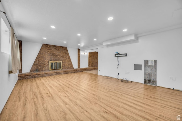 5350 S 3450 W, Roy, UT 84067 - unfurnished living room featuring a brick fireplace, wood finished floors, and recessed lighting