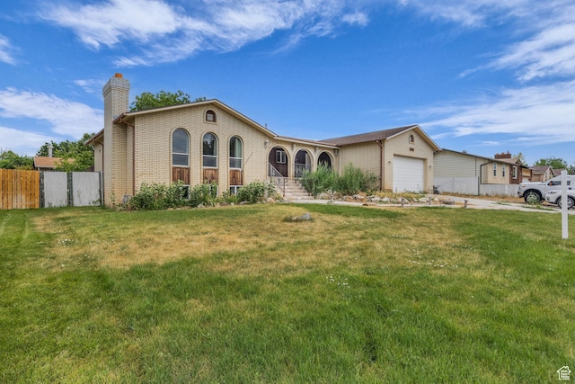 5350 S 3450 W, Roy, UT 84067 - view of front of house with a chimney, an attached garage, brick siding, and concrete driveway