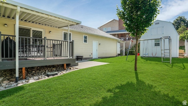 1138 Briggs Dr, Bountiful, UT 84010 - view of green lawn with a wooden deck and a storage unit
