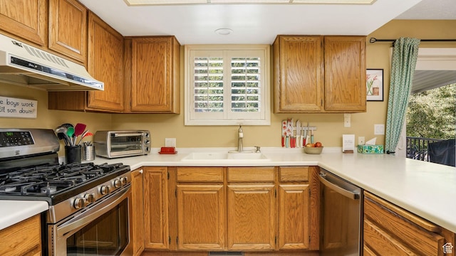 1138 Briggs Dr, Bountiful, UT 84010 - kitchen featuring appliances with stainless steel finishes, under cabinet range hood, brown cabinets, and light countertops