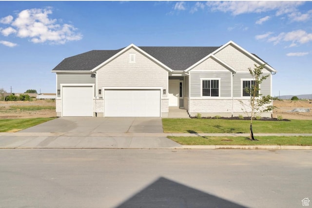 1086 S 3170 E Unit 217, Spanish Fork, UT 84660 - view of front of home featuring driveway, a garage, a front lawn, and a shingled roof