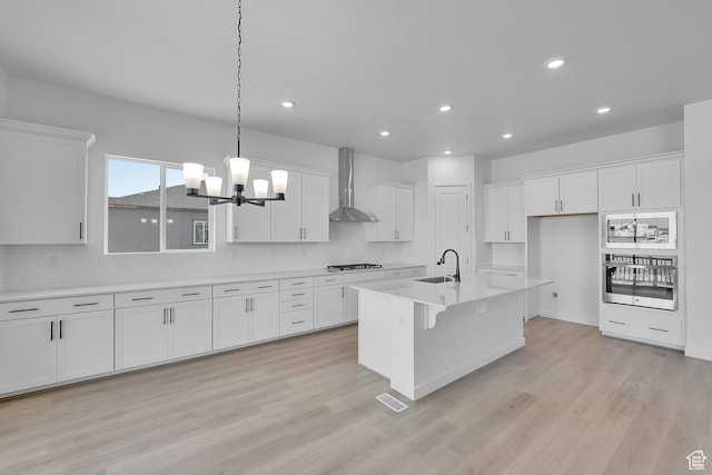 1086 S 3170 E Unit 217, Spanish Fork, UT 84660 - kitchen with appliances with stainless steel finishes, wall chimney exhaust hood, white cabinetry, and recessed lighting