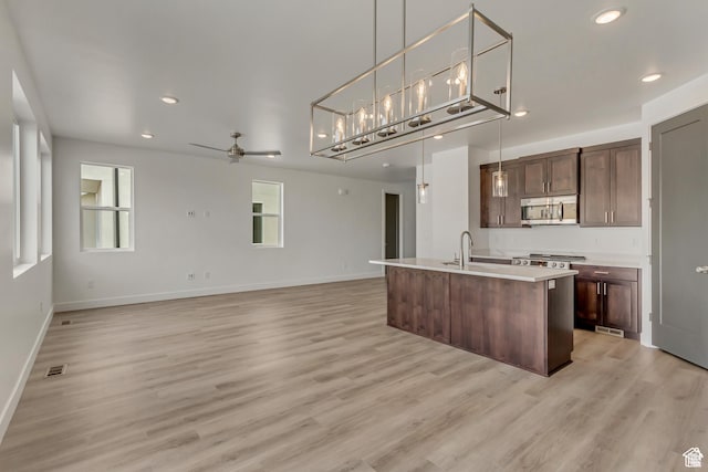 1352 N 1440 E Unit 21, Payson, UT 84651 - kitchen featuring stainless steel microwave, a ceiling fan, open floor plan, light wood-type flooring, and recessed lighting