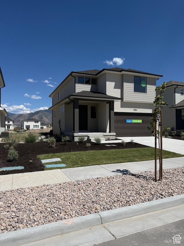 1352 N 1440 E Unit 21, Payson, UT 84651 - view of front facade with a garage, concrete driveway, a mountain view, and stucco siding