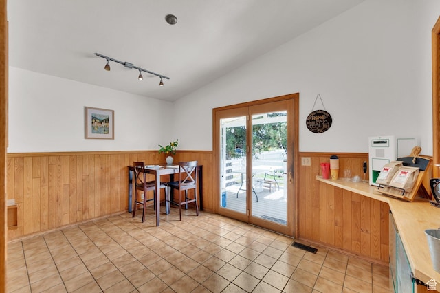 1481 W Bluemont Dr, Murray, UT 84123 - dining space featuring a wainscoted wall, track lighting, wooden walls, light tile patterned flooring, and vaulted ceiling