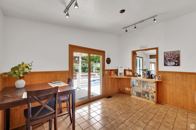 1481 W Bluemont Dr, Murray, UT 84123 - dining space featuring rail lighting, wainscoting, wooden walls, and light tile patterned floors