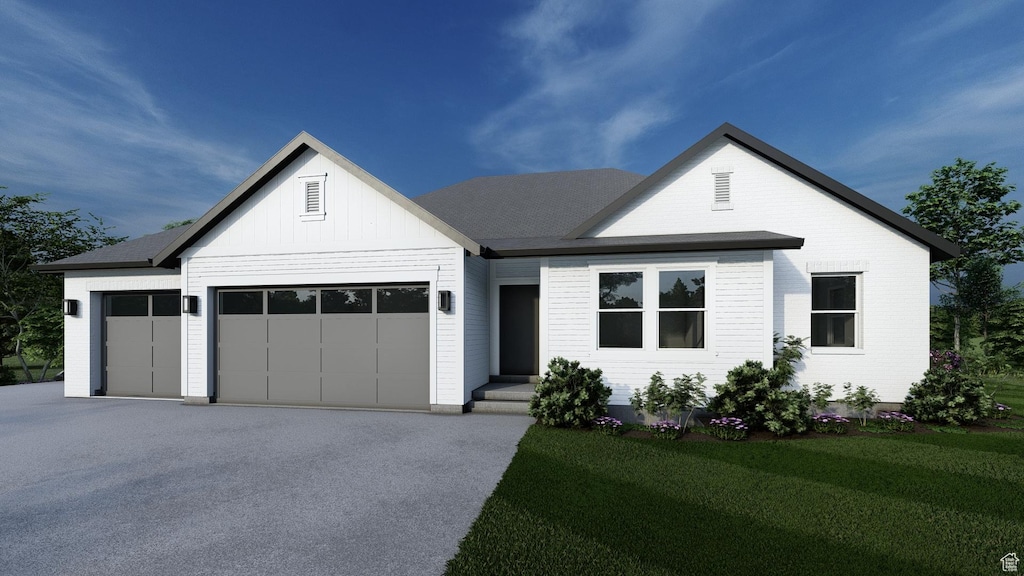 444 E 1600 S Unit 1, Orem, UT 84058 - view of front of house with a garage, driveway, a front yard, and board and batten siding