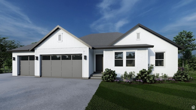 444 E 1600 S Unit 1, Orem, UT 84058 - view of front of house with a garage, driveway, a front yard, and board and batten siding