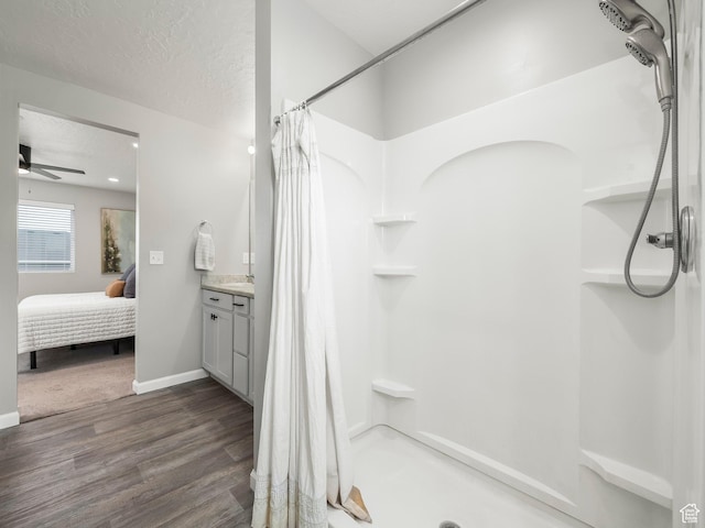 1493 N Sunset Dr, Spanish Fork, UT 84660 - full bath with a shower stall, wood finished floors, vanity, a ceiling fan, and connected bathroom