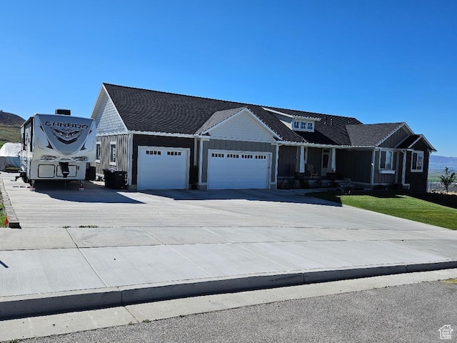 1268 E 300 S, Smithfield, UT 84335 - view of front facade featuring a garage, driveway, and board and batten siding