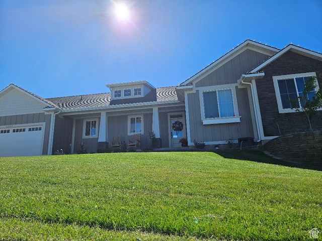 1268 E 300 S, Smithfield, UT 84335 - view of front of home with board and batten siding, a garage, a front lawn, and a porch