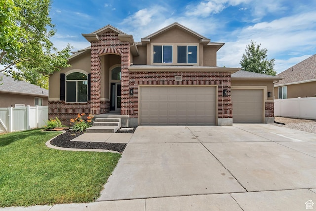 13749 S Crimson Patch Way, Riverton, UT 84096 - view of front facade with stucco siding, concrete driveway, an attached garage, and brick siding