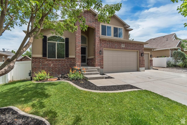 13749 S Crimson Patch Way, Riverton, UT 84096 - view of front of house featuring brick siding, stucco siding, concrete driveway, and a garage