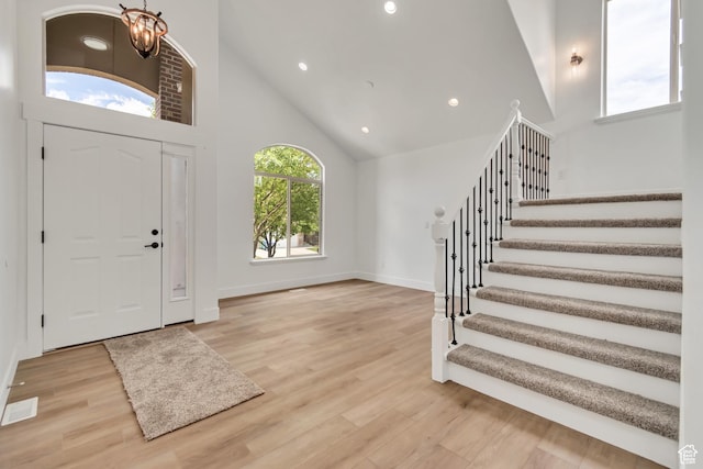 13749 S Crimson Patch Way, Riverton, UT 84096 - entrance foyer featuring high vaulted ceiling, stairway, wood finished floors, recessed lighting, and a chandelier