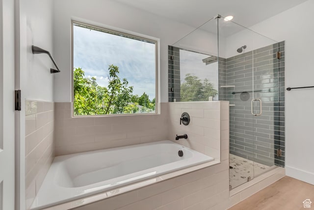 13749 S Crimson Patch Way, Riverton, UT 84096 - bathroom featuring a garden tub, a stall shower, and wood finished floors