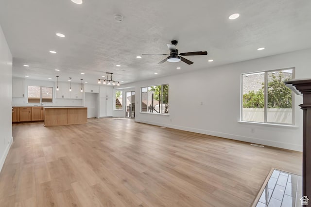 13749 S Crimson Patch Way, Riverton, UT 84096 - unfurnished living room featuring recessed lighting, ceiling fan, and light wood-type flooring